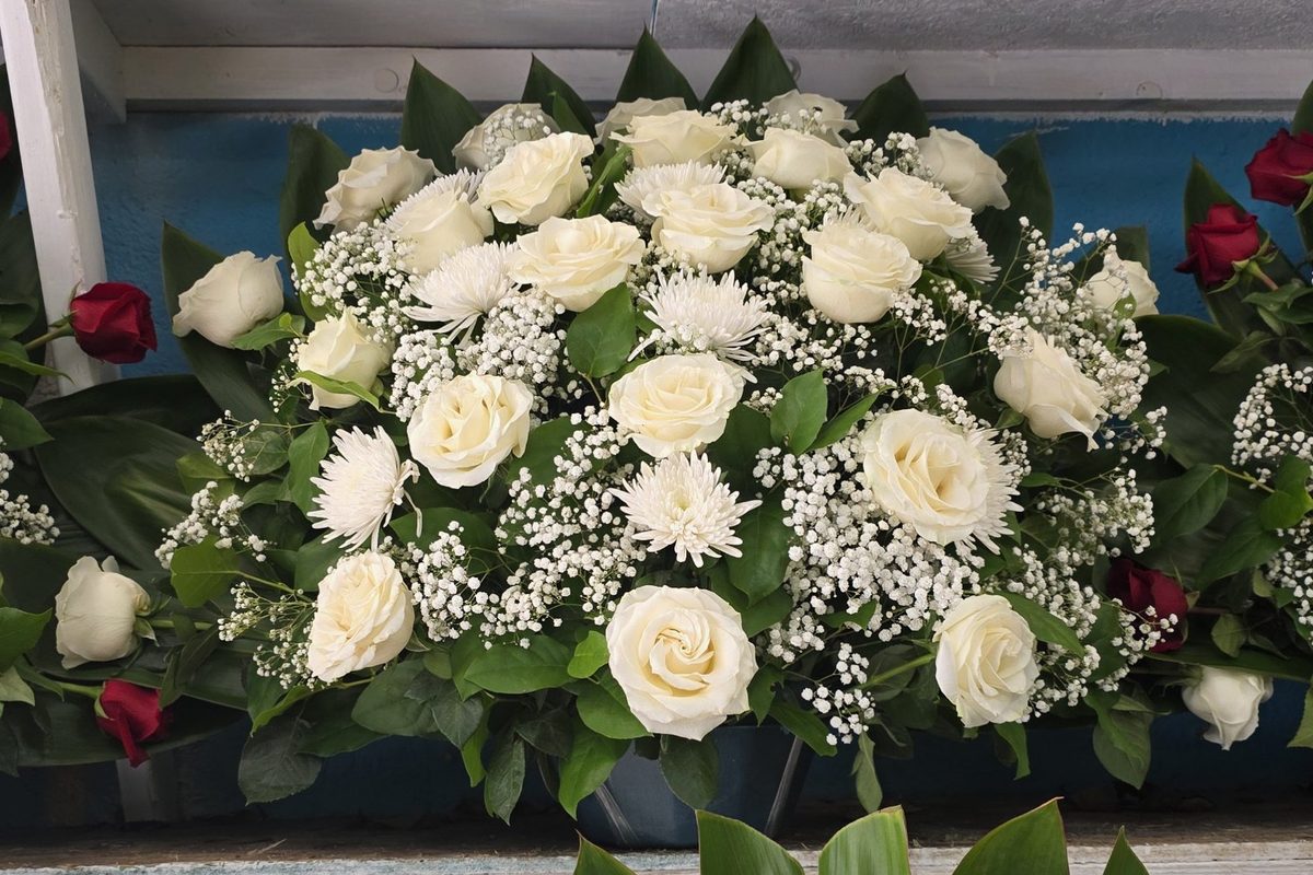 Large white rose arrangement for a baptism celebration