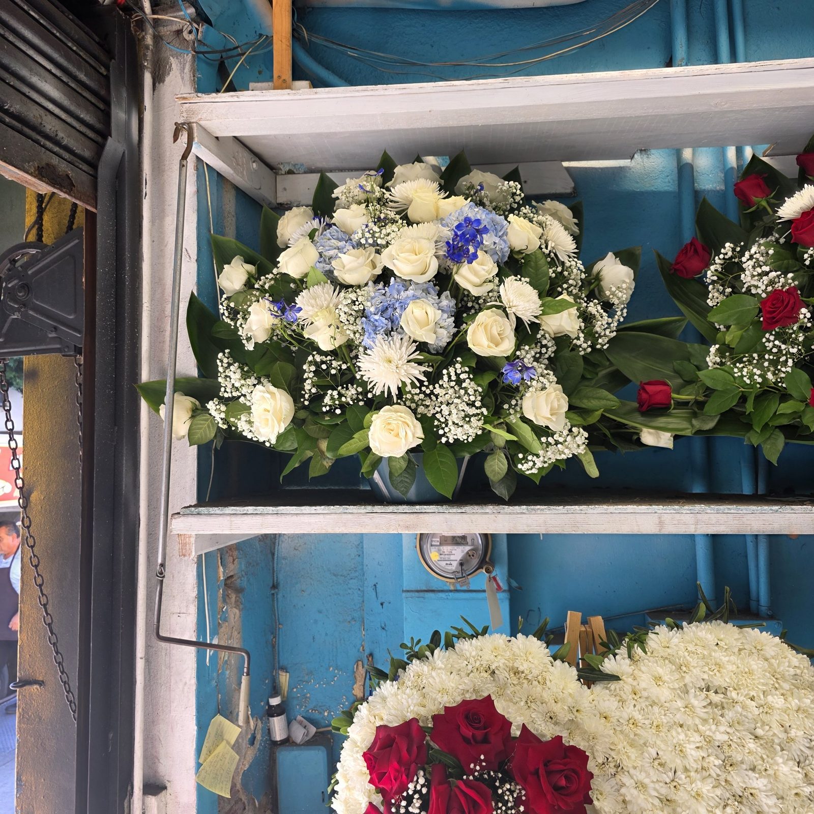 White and blue floral arrangement in a vase