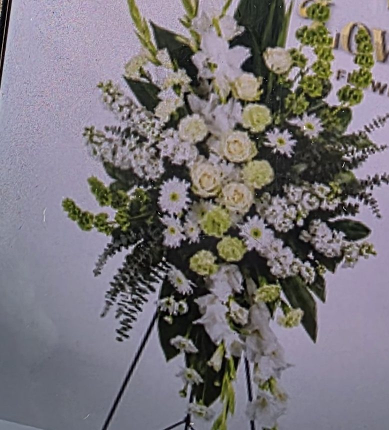 White standing funeral spray of lilies and seasonal whites